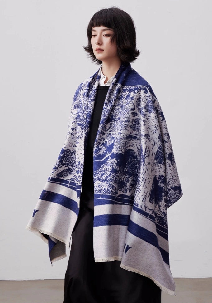 Blue and ivory large brushed silk scarf worn as an oversized shawl with elegant artistic print