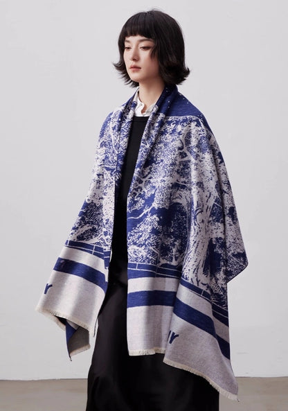 Blue and ivory large brushed silk scarf worn as an oversized shawl with elegant artistic print