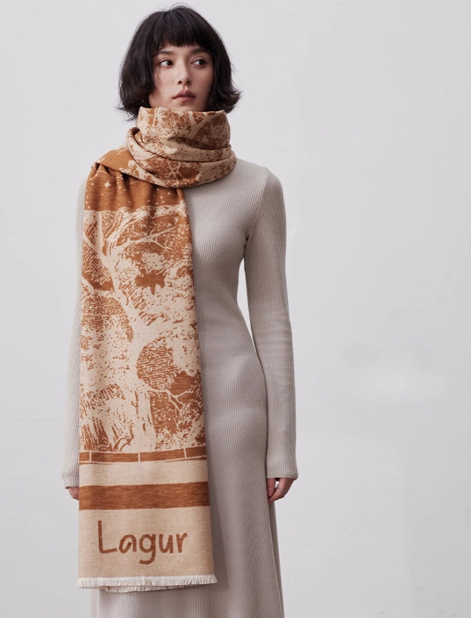 Model wearing a brown brushed silk scarf as a long winter wrap with artistic print and soft fringe