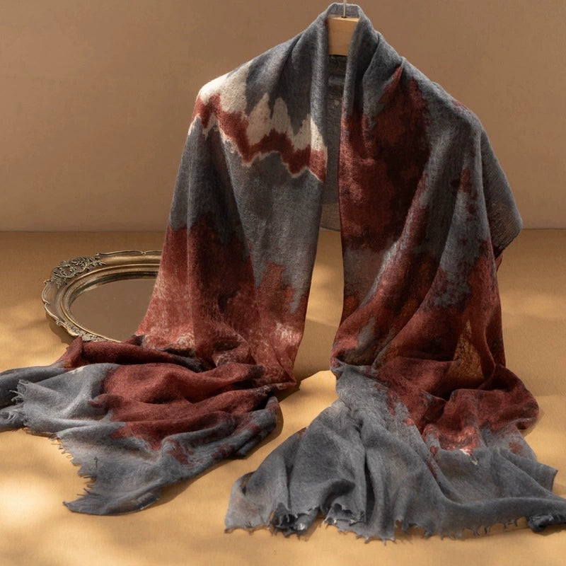 Luxury cashmere scarf in burgundy with an abstract tie-dye pattern, showcasing soft and elegant fabric.