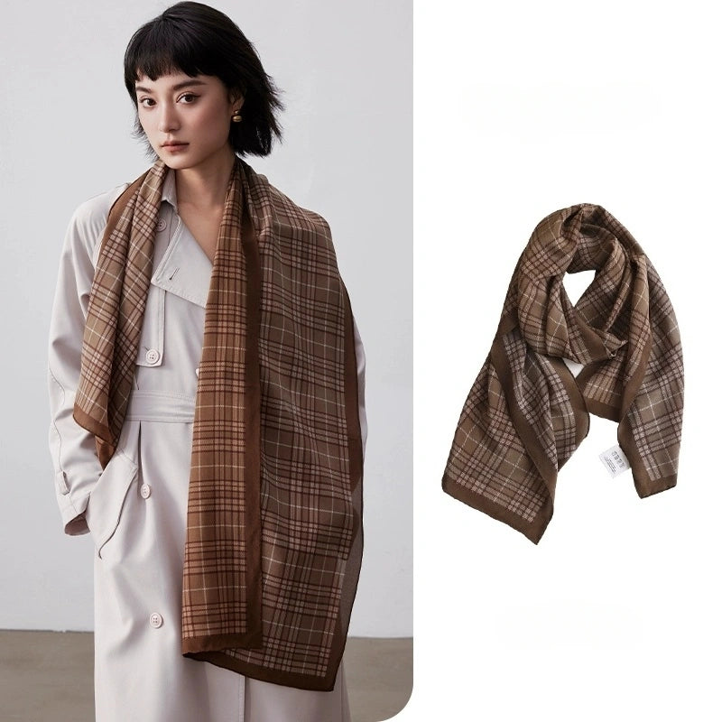 Coffee plaid long silk scarf styled over a white trench coat with matching flat lay detail