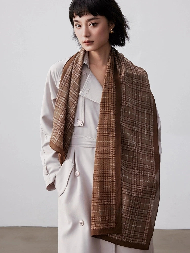 Coffee plaid long silk scarf draped elegantly over a white outfit