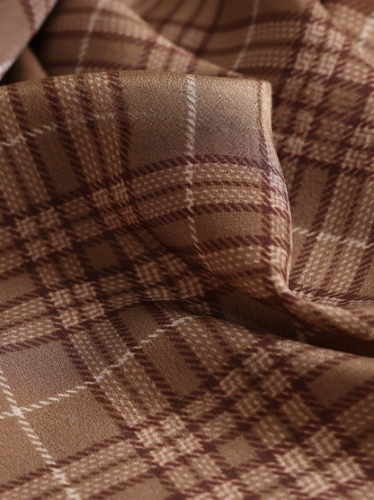 Close-up of coffee plaid silk scarf highlighting soft texture and woven check details
