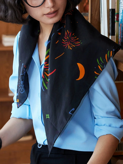 Ballet Nocturne silk square scarf draped over the shoulders with colorful fireworks and dancer motifs