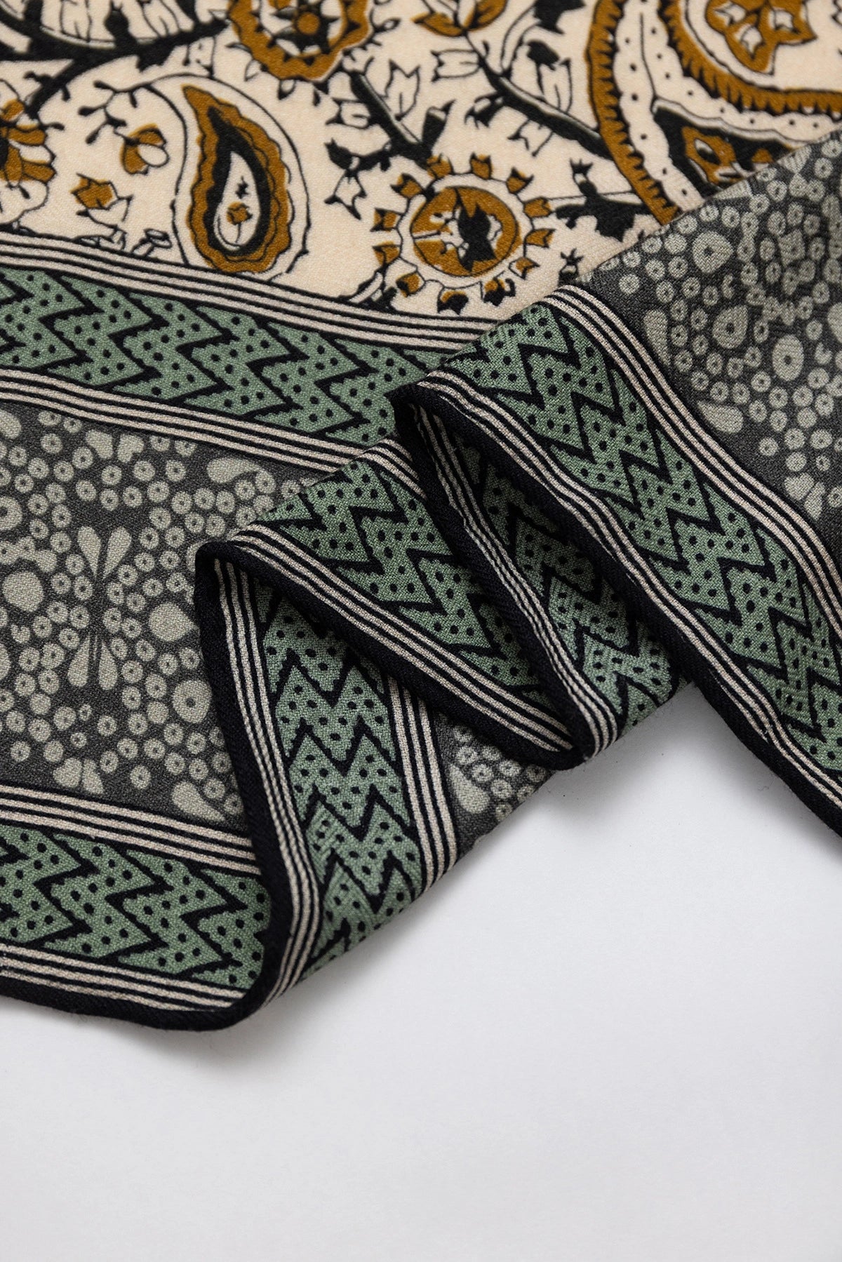 Silk Wool Square Scarf – Vintage Paisley Design | Green, 130*130cm, close-up of edge, highlighting detailed paisley patterns, luxurious scarf.