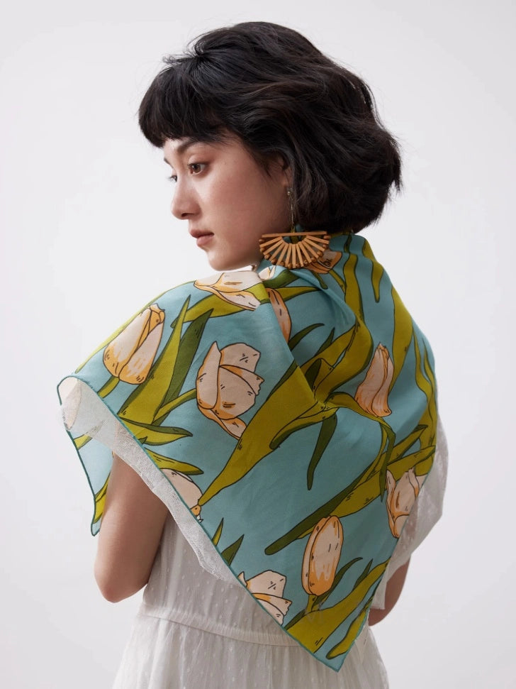 Green tulip floral silk scarf draped across the back for elegant styling