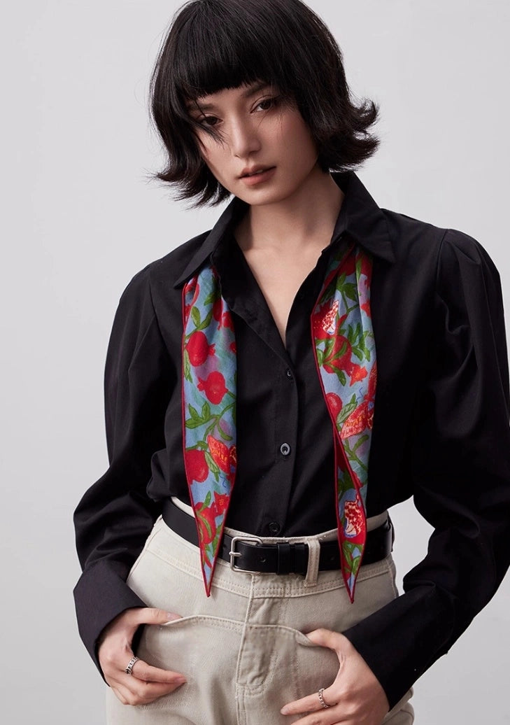 Lupine blue silk triangle scarf worn as a neck scarf with a black shirt