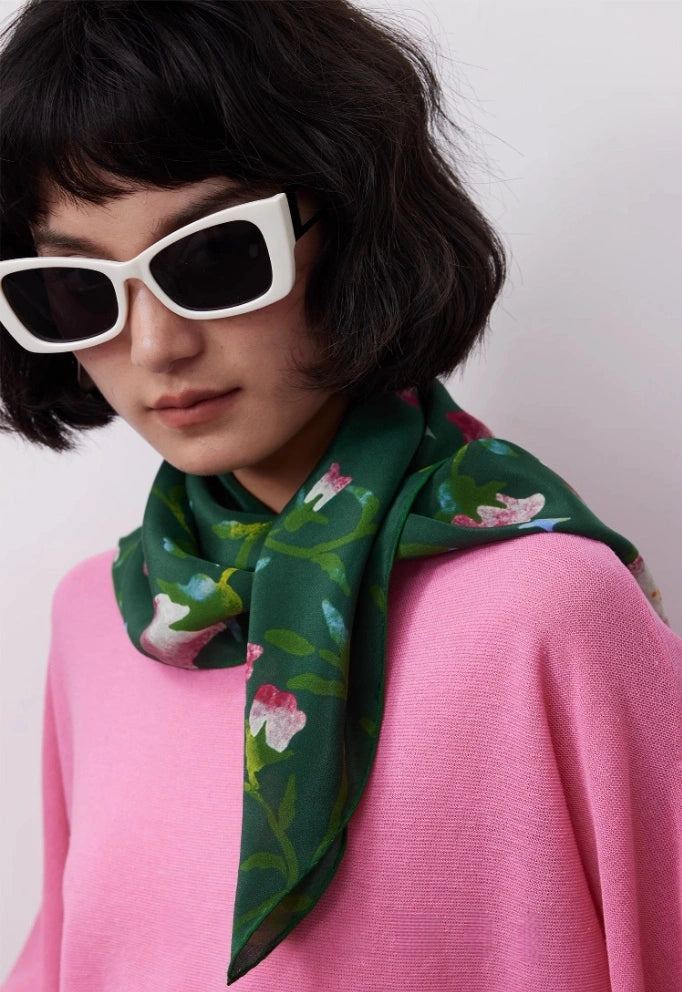 Wilderness Green silk square scarf styled as a neck accessory, demonstrating its charm and versatility.