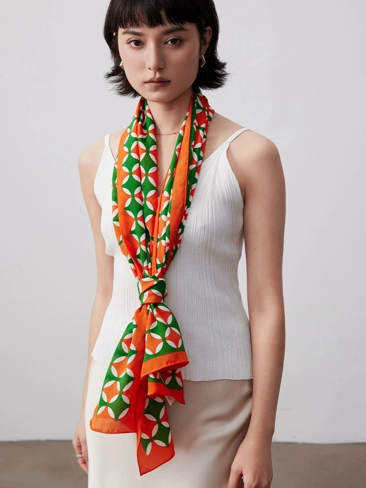 Orange green geometric silk scarf tied as a long neck scarf