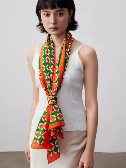 Orange green geometric silk scarf tied as a long neck scarf