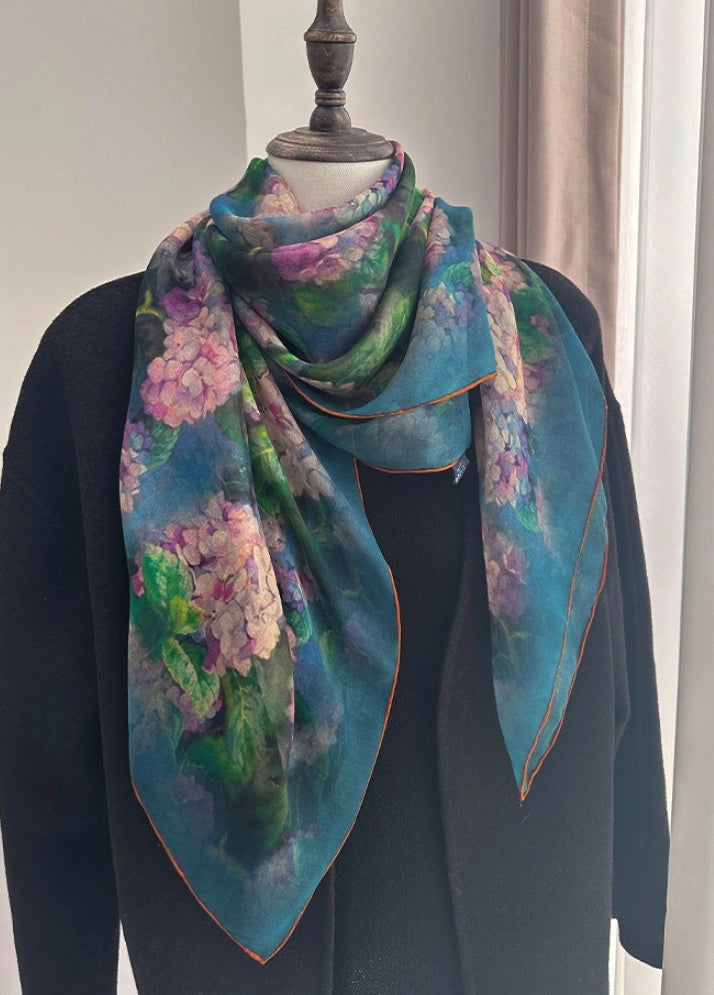 Green floral plant-dyed silk scarf wrapped around a mannequin for elegant styling