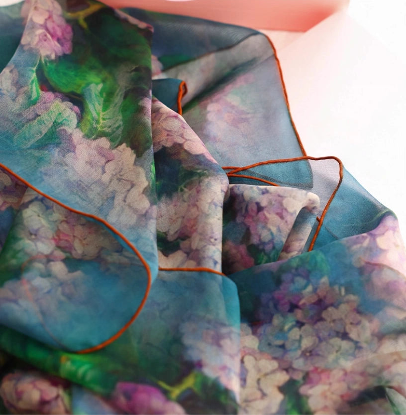 Close-up of green and pink floral silk scarf with soft artistic print