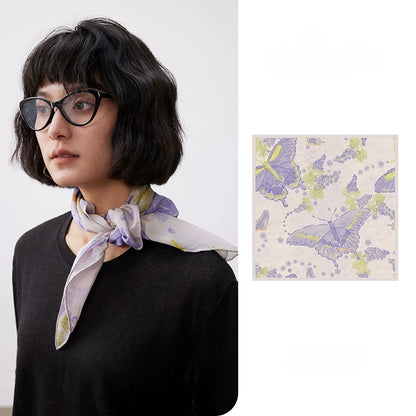 Purple butterfly print silk square scarf tied around the neck with matching flat lay detail