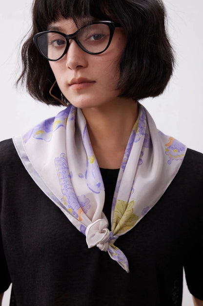 Purple butterfly silk square scarf tied as a neck scarf with a black top