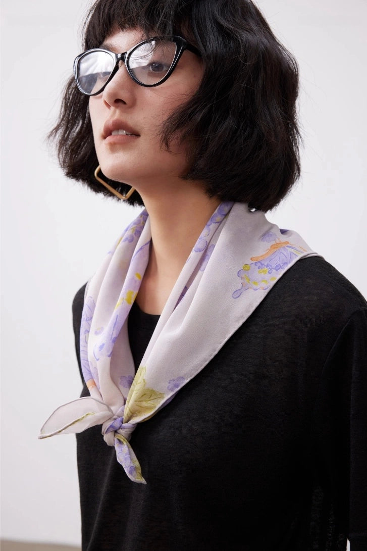 Elegant purple butterfly print silk square scarf styled with a black outfit