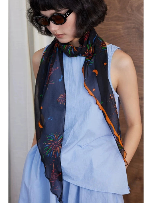 Black fireworks silk scarf styled as a long skinny neck scarf with a soft elegant drape