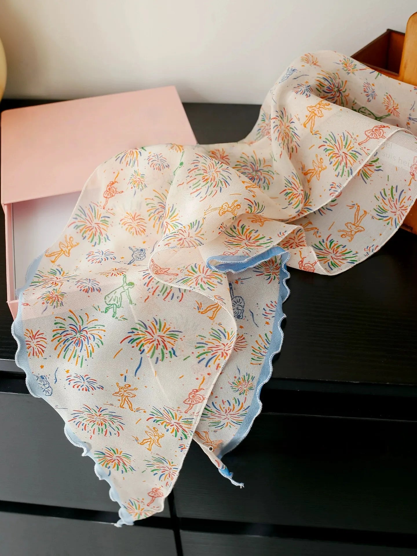 White fireworks mulberry silk skinny scarf displayed flat to show its delicate print and sheer georgette texture