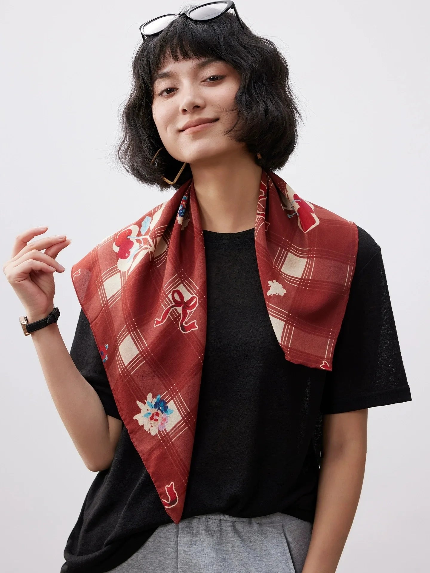 Burgundy cherry print silk square scarf worn as a neck scarf, lightweight 100% mulberry silk accessory for women