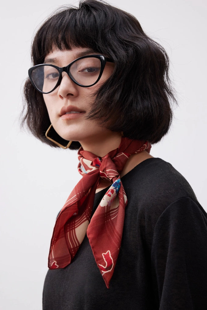 Vintage plaid silk bandana with cherry pattern, styled around the neck for a romantic retro-inspired look