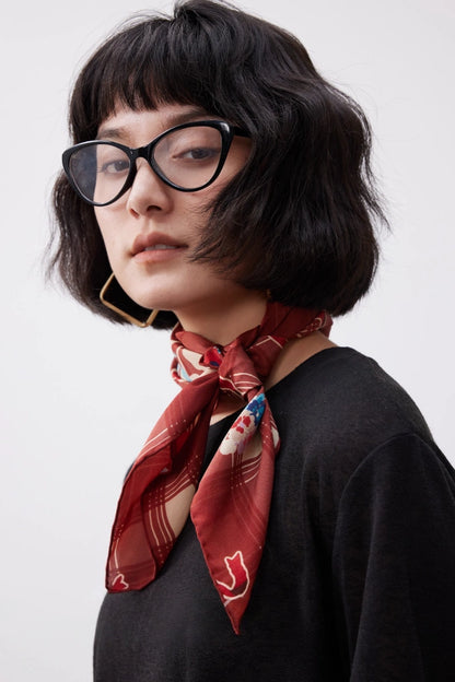Vintage plaid silk bandana with cherry pattern, styled around the neck for a romantic retro-inspired look