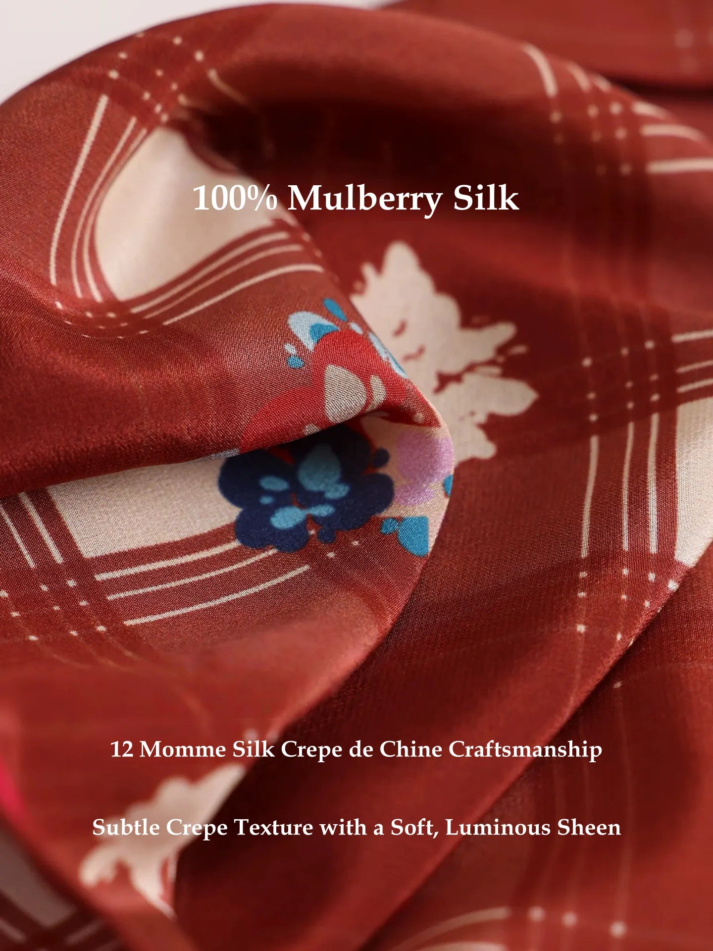 Close-up of burgundy cherry plaid mulberry silk scarf showing soft silk texture, sheen, and printed pattern