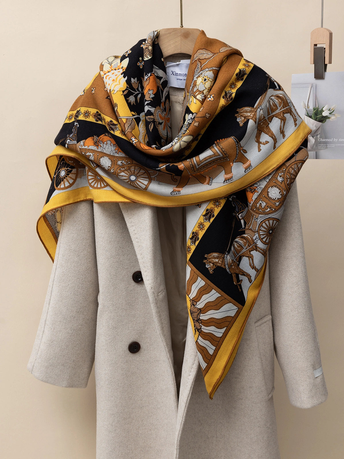 Silk-wool square scarf - Persimmon tree print | Yellow, 130×130 cm, draped over a coat to showcase versatile styling options.