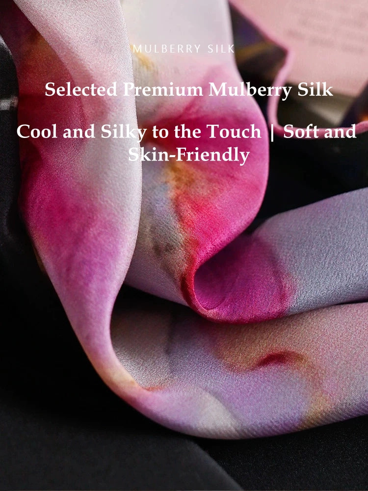 Close-up of premium mulberry silk scarf fabric with smooth satin texture and soft floral colors