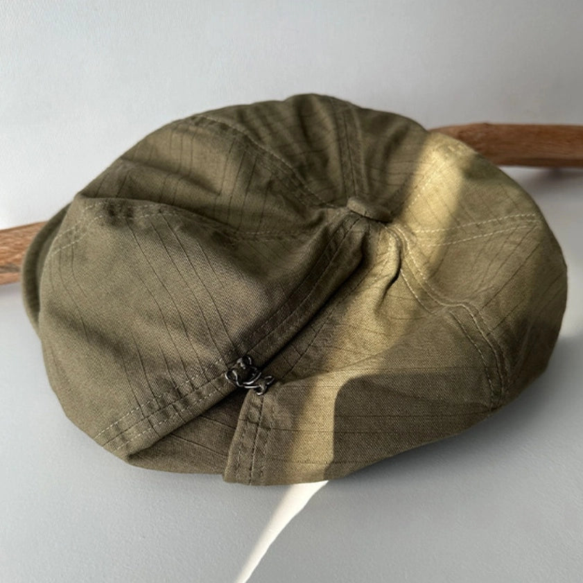 Bean green cotton beret hat side detail with breathable fabric texture and adjustable elastic design