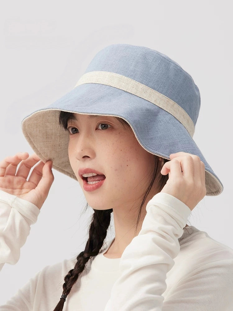 Side view of a beige blue reversible sun hat with contrast trim and curved brim