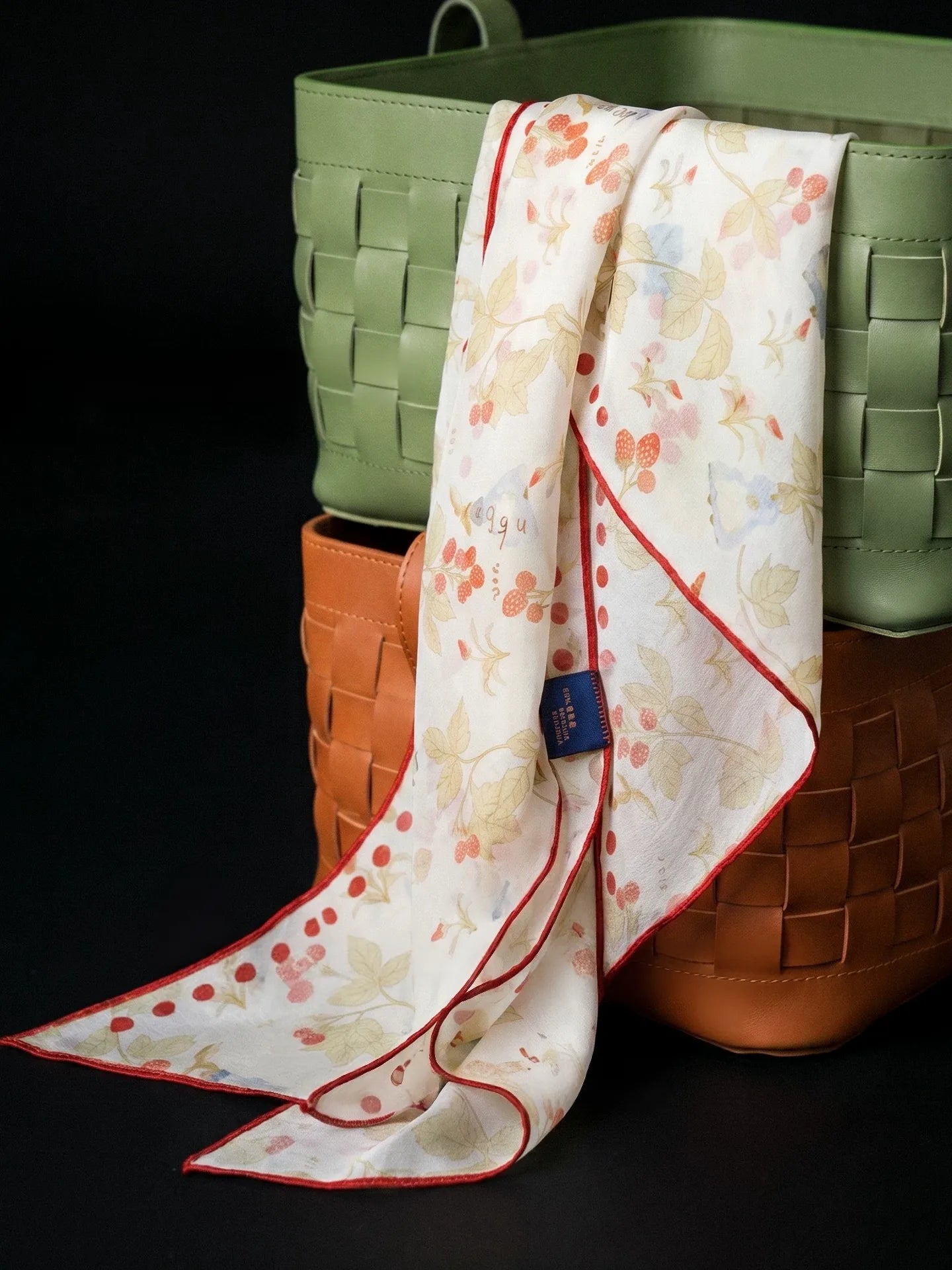Long berry rabbit print mulberry silk scarf draped over colorful blocks