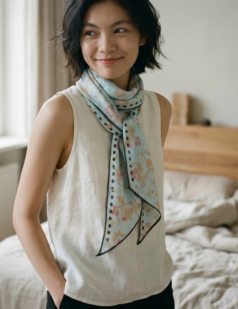 Sky blue rabbit print mulberry silk scarf loosely wrapped over a sleeveless white top