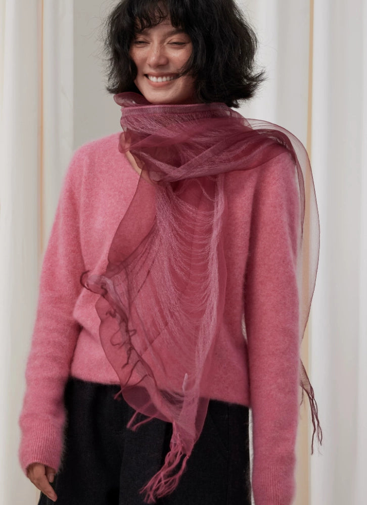 Woman styling a lightweight berry silk fringe scarf over a tonal pink outfit