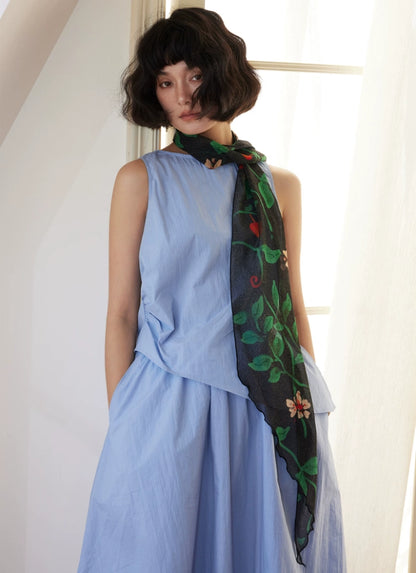 Model wearing black botanical silk georgette skinny scarf with blue dress
