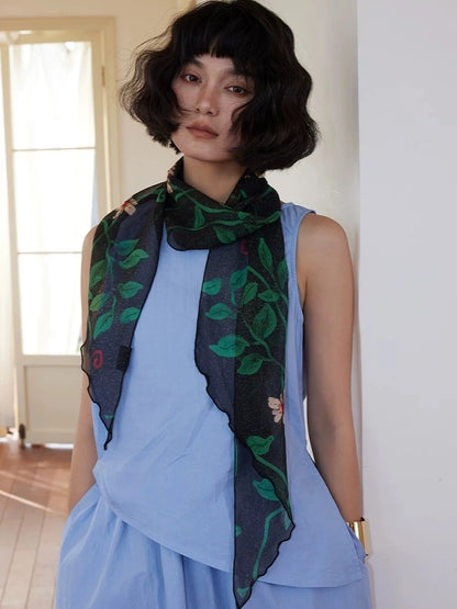 Lightweight black floral silk georgette scarf draped over a blue dress