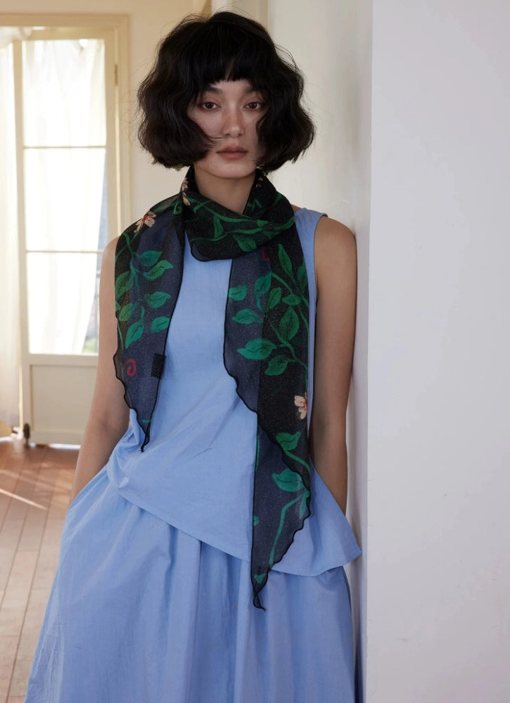 Black floral long silk scarf worn with a sleeveless blue outfit