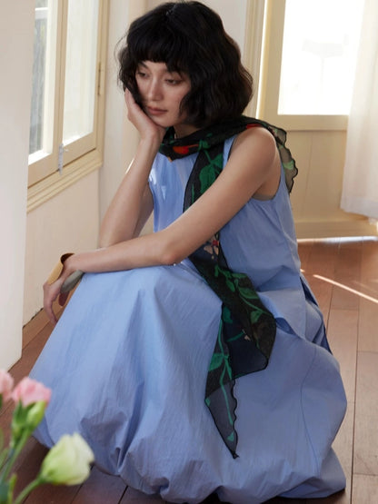 Model styling a black botanical silk georgette scarf with relaxed elegance