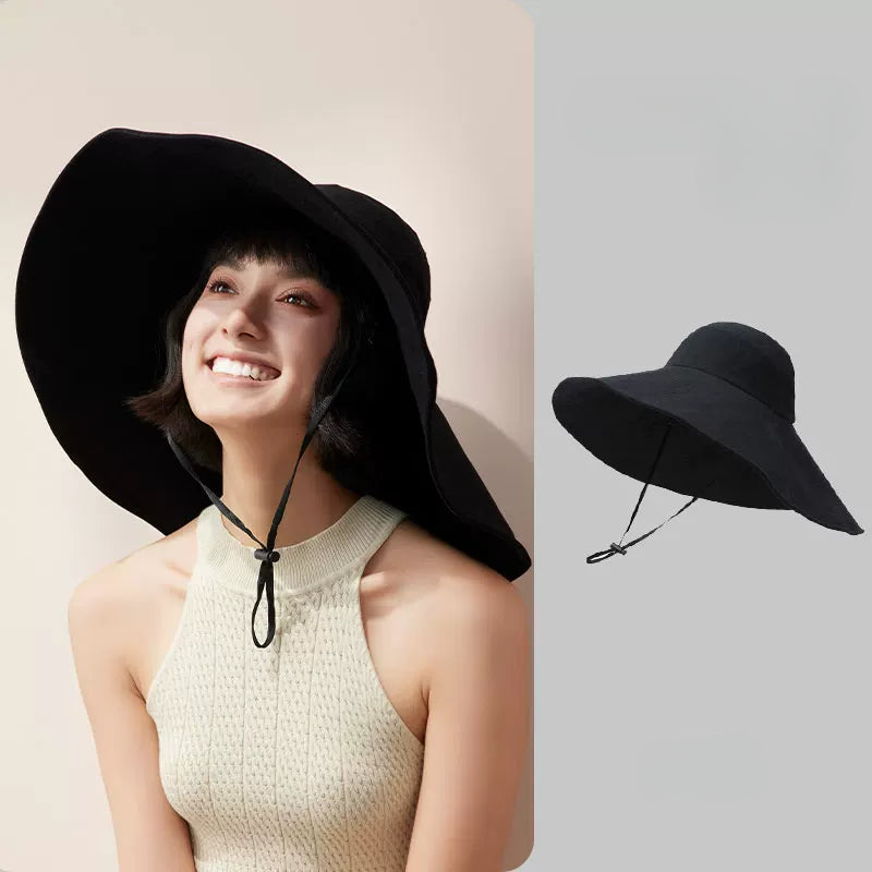 Woman wearing black cotton oversized wide brim sun hat with wind cord, shown with product view