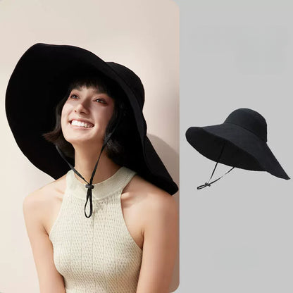 Woman wearing black cotton oversized wide brim sun hat with wind cord, shown with product view