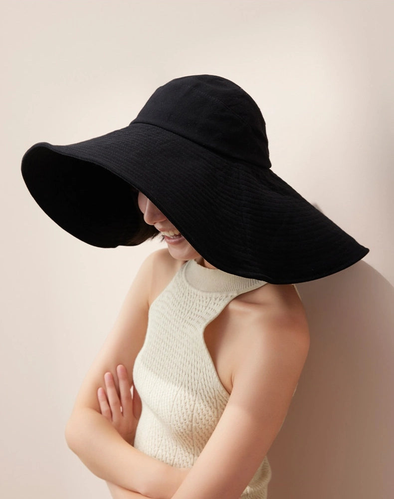 Side view of black cotton wide brim sun hat with oversized floppy brim for summer wear