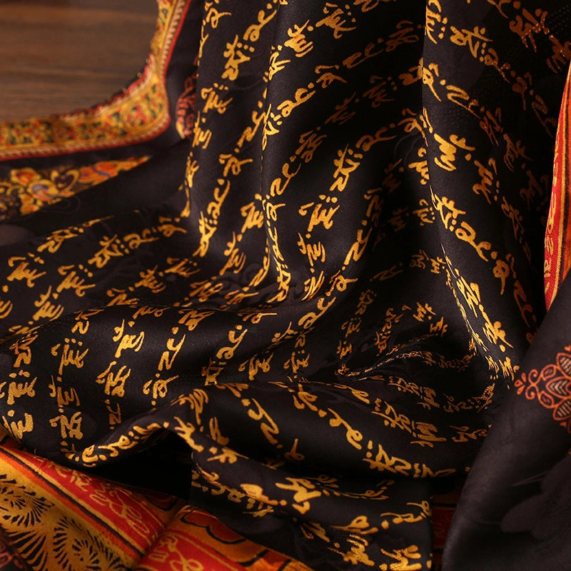 Close-up of gold mantra script printed on black Xiangyun mulberry silk