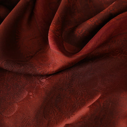 Close-up of the deep burgundy texture and subtle sheen of traditional Xiangyun silk