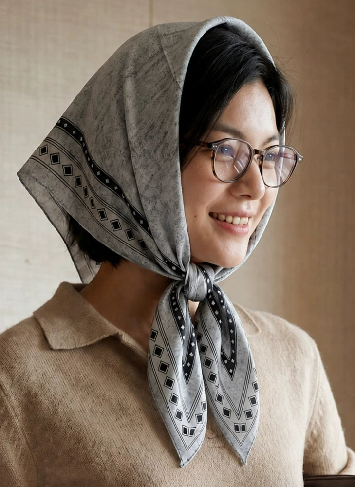 Black and gray geometric silk wool scarf styled as a vintage headscarf