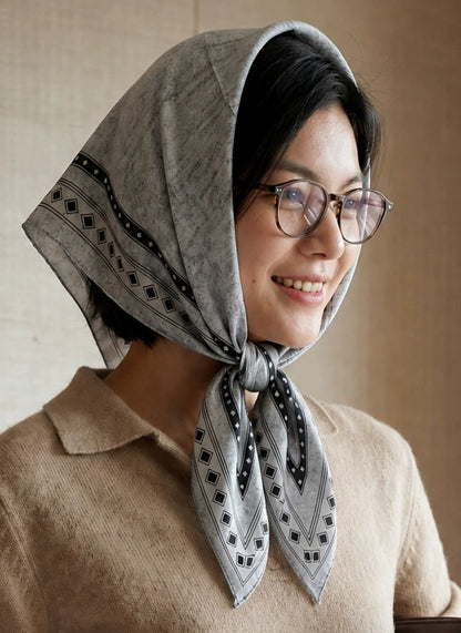 Black and gray geometric silk wool scarf styled as a vintage headscarf