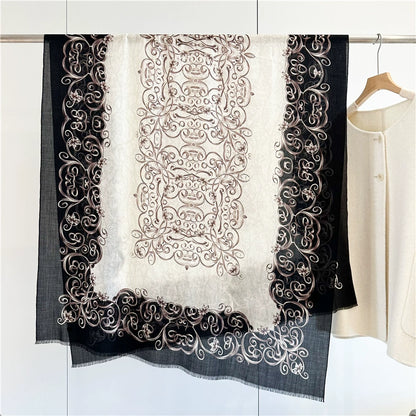 Black and ivory Baroque swirl fine wool scarf displayed flat with ornate borders and fringed edges