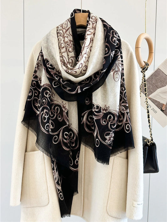 Black and ivory Baroque wool scarf looped loosely over an ivory coat with patterned ends