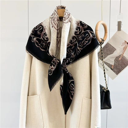 Black and ivory Baroque wool scarf crossed at the front over a cream coat