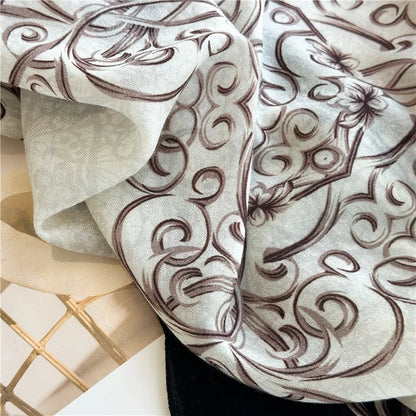 Close-up of the ivory wool scarf panel with taupe Baroque swirl pattern