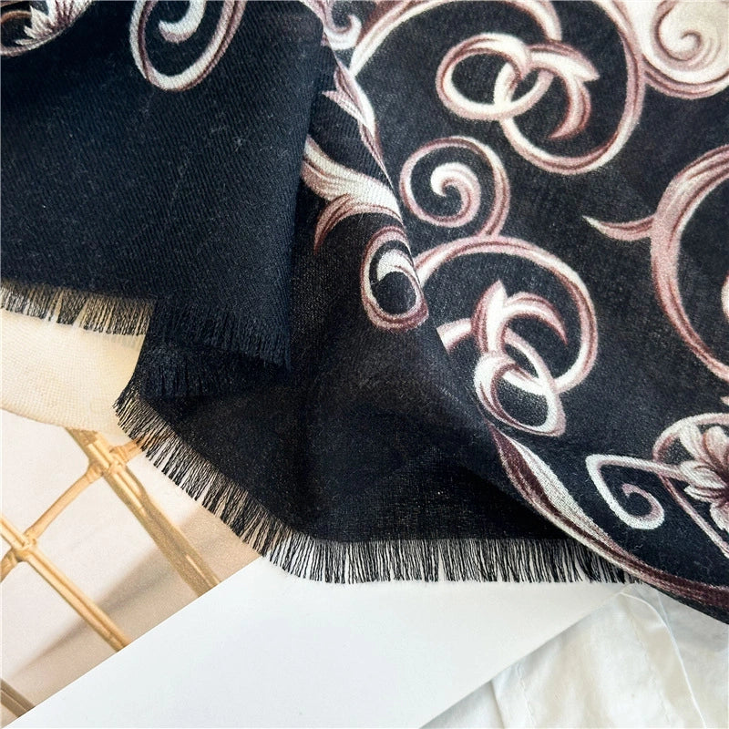 Close-up of the black Baroque scroll border and fine fringe on the wool scarf