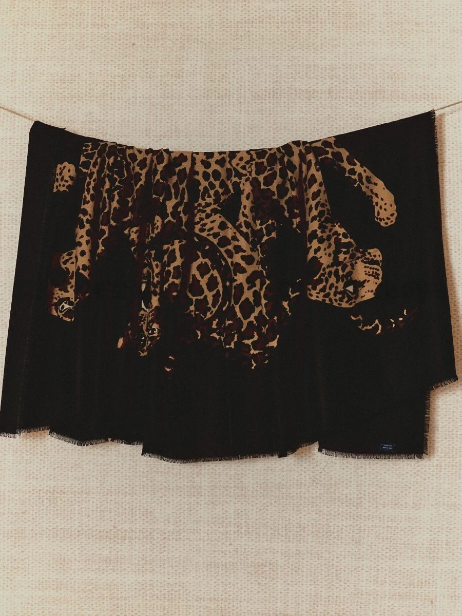 Black oversized wool scarf with artistic leopard graphic, displayed flat to show the full animal print design