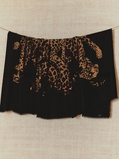 Black oversized wool scarf with artistic leopard graphic, displayed flat to show the full animal print design